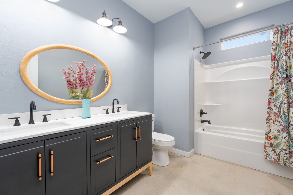 33 Deer Ridge Road Wimberley, TX 78676 - Photo 28 of 40 a bathroom with a double vanity sink mirror and toilet