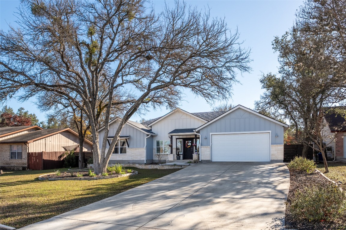 33 Deer Ridge Road Wimberley, TX 78676 - Photo 4 of 40 a front view of a house with a yard