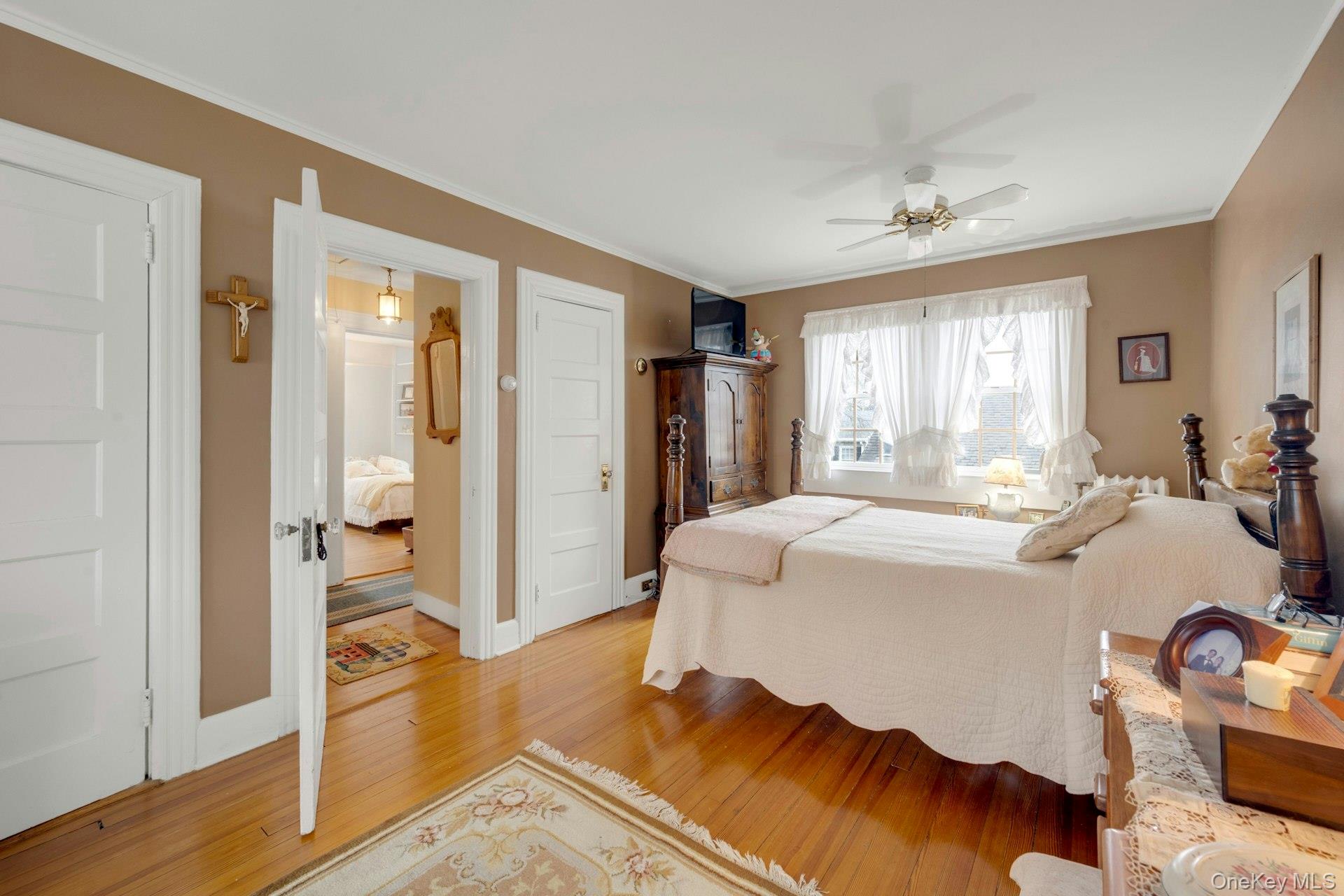 343 Rye Beach Avenue Rye, NY 10580 - Photo 18 of 35 a spacious bedroom with a bed and wooden floor