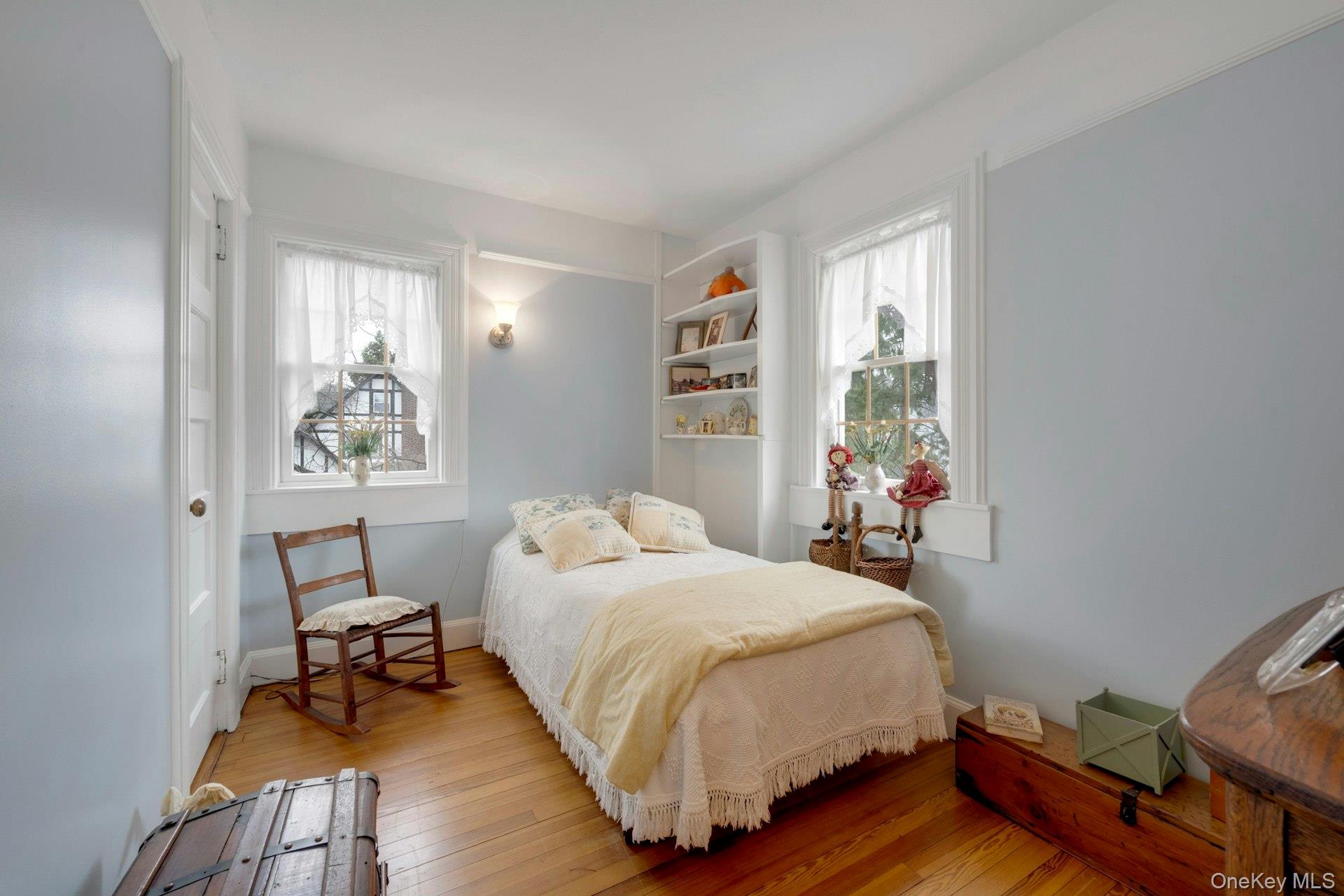 343 Rye Beach Avenue Rye, NY 10580 - Photo 23 of 35 a bedroom with a bed and wooden floor