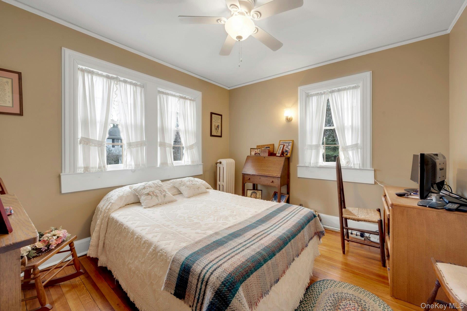 343 Rye Beach Avenue Rye, NY 10580 - Photo 24 of 35 a bedroom with a bed and a chandelier