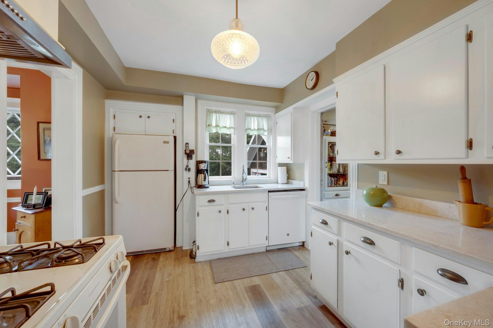 343 Rye Beach Avenue Rye, NY 10580 - Photo 10 of 35 a kitchen with cabinets stainless steel appliances and wooden floor