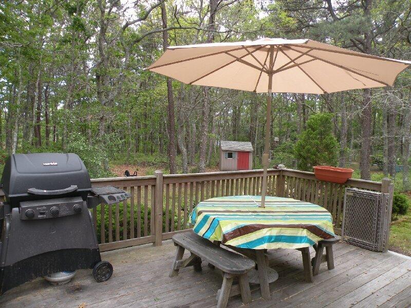 27 Pine View Drive Brewster, MA 02631 - Photo 3 of 17 a roof deck with a table and chairs under an umbrella