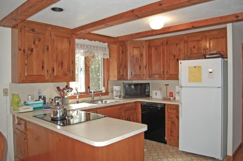 27 Pine View Drive Brewster, MA 02631 - Photo 7 of 17 a kitchen with a sink a stove and cabinets