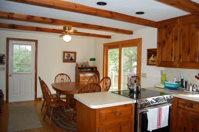 27 Pine View Drive Brewster, MA 02631 - Photo 9 of 17 a dining room with stainless steel appliances granite countertop a dining table and chairs with wooden floor