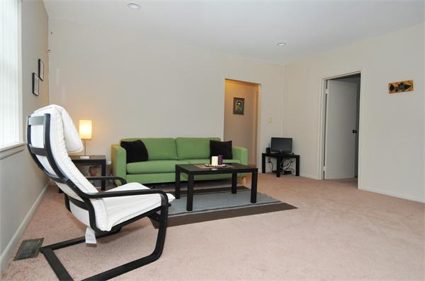 120 Lake Shore Road, Unit 1 Boston, MA 02135 - Photo 3 of 15 a living room with furniture a rug and a window