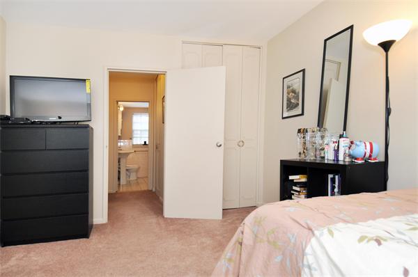 120 Lake Shore Road, Unit 1 Boston, MA 02135 - Photo 5 of 15 a bedroom with a bed and a flat tv screen