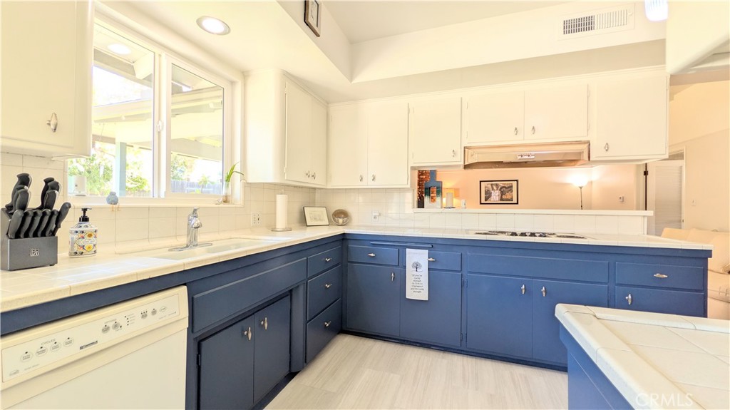 1418 Niagara Avenue Claremont, CA 91711 - Photo 10 of 29 a kitchen with kitchen island granite countertop a sink window and cabinets