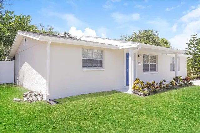 a front view of a house with a garden