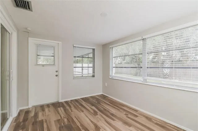 wooden floor in an empty room with a window