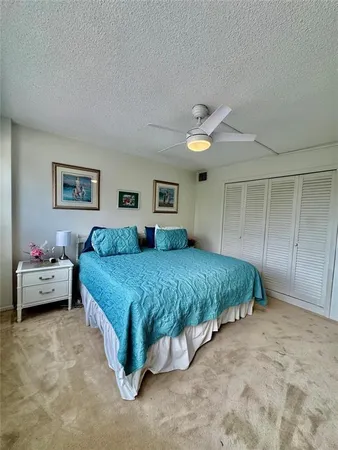 a bedroom with two beds and painting on the wall