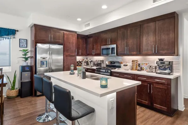 a kitchen with a sink a stove a refrigerator and cabinets