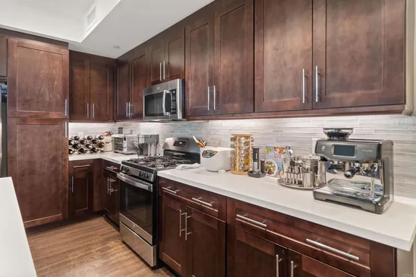 a kitchen with sink cabinets and stainless steel appliances