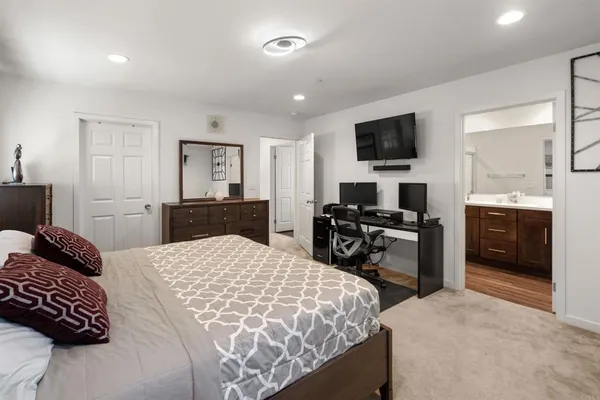 a bedroom with a bed and a television