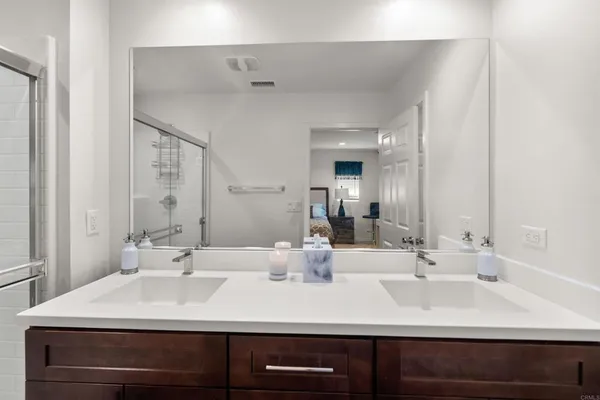 a bathroom with a sink double vanity and a mirror