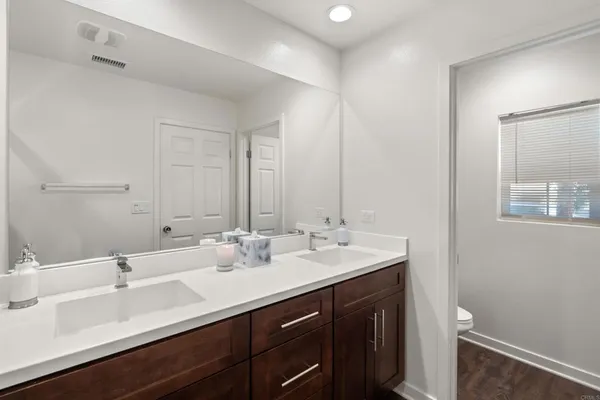 a bathroom with double sink and a mirror