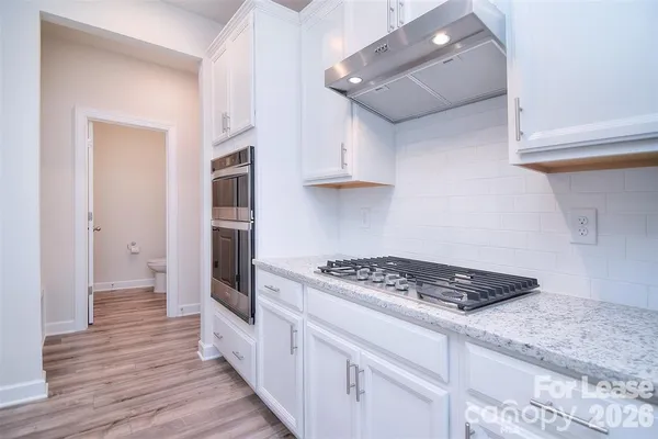 a kitchen with stainless steel appliances granite countertop a stove and a refrigerator
