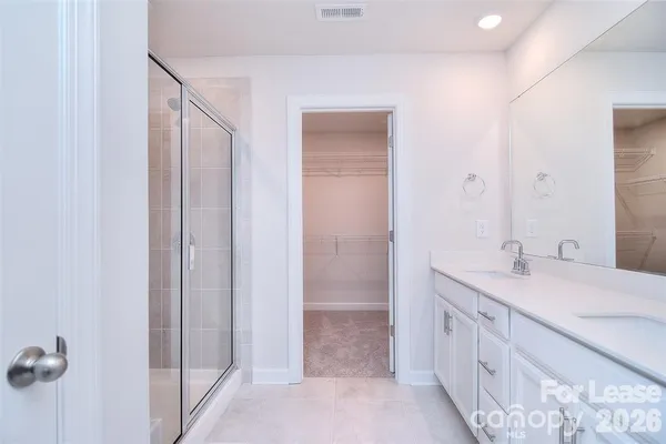 a bathroom with a double vanity sink and mirror
