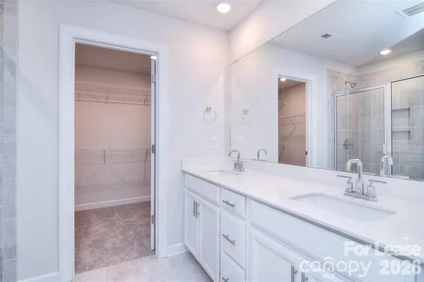 a bathroom with a sink double vanity and a mirror