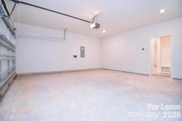 an empty room with a ceiling fan and window