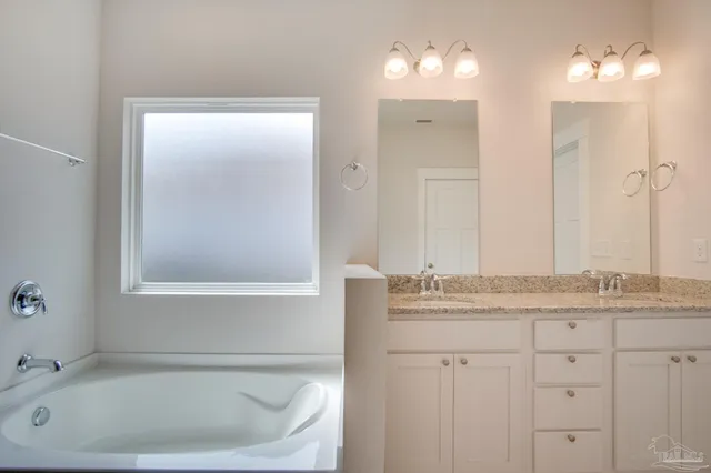 a bathroom with a bathtub and a sink
