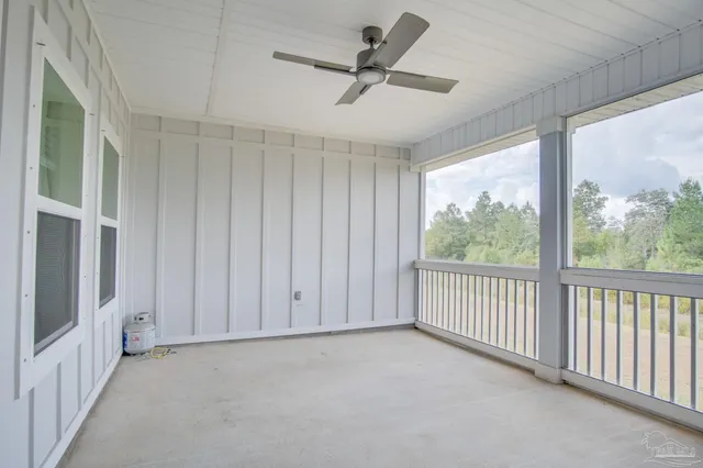 a view of a livingroom with a ceiling fan and window