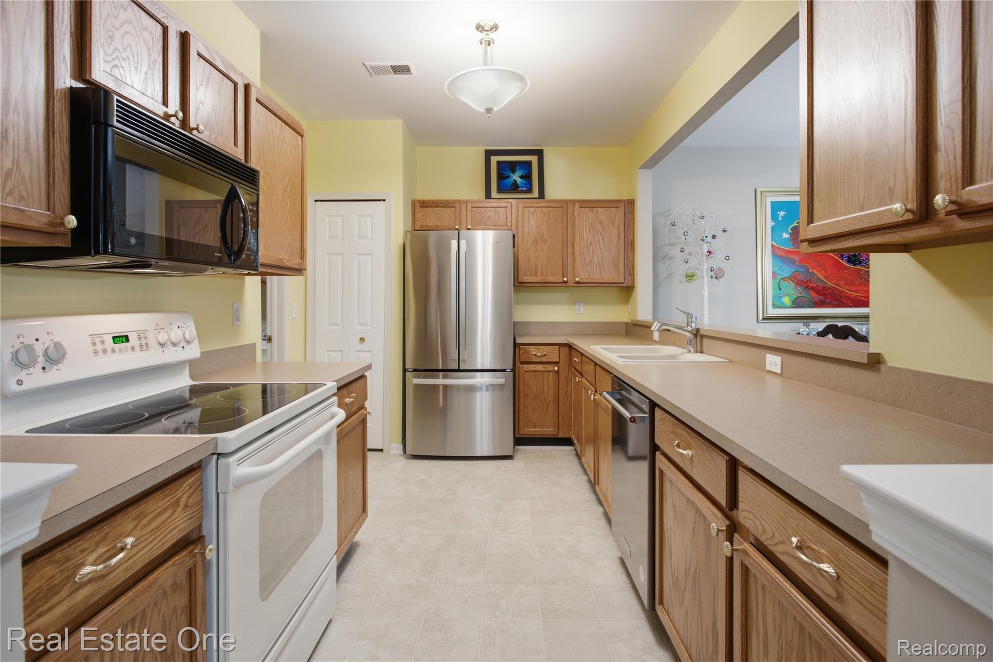 1828 Flagstone Circle, Unit 40 Rochester, MI 48307 - Photo 13 of 22 Galley kitchen featuring wood cabinetry, stone-look countertops, and recessed lighting