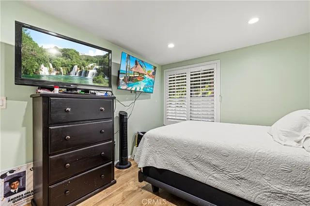 a bedroom with a bed dresser and a window