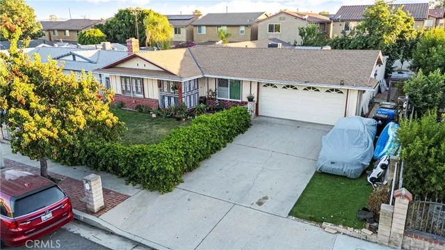 an aerial view of a house with a yard and potted plants
