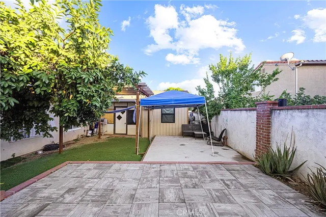 an aerial view of a house with a yard and seating space