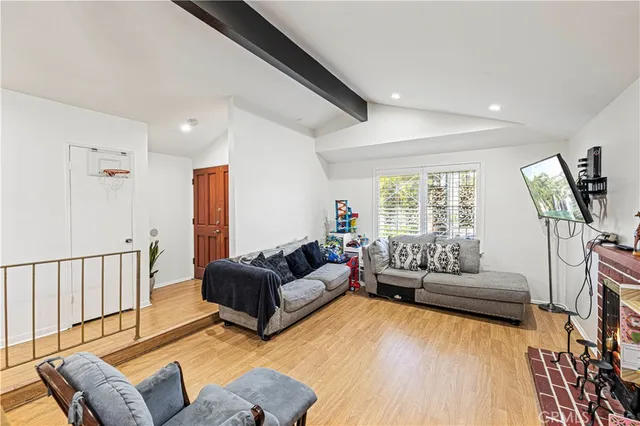 a living room with furniture a couch and a window