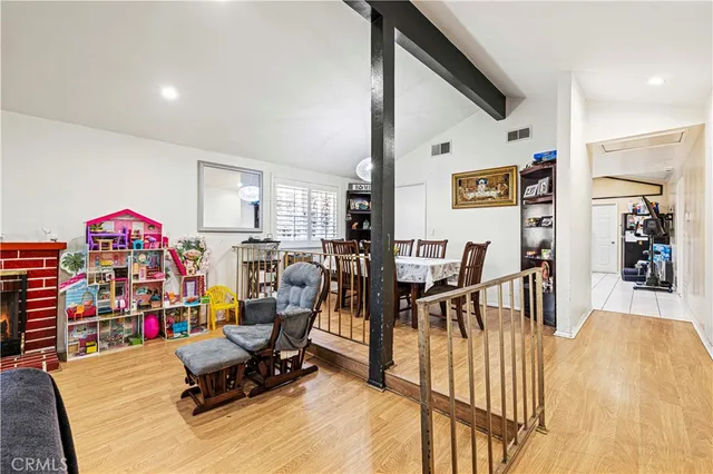 a living room filled with furniture and a wooden floor