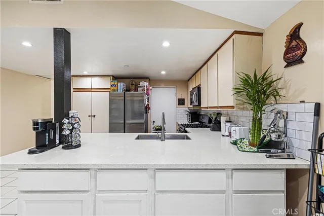 a kitchen with a sink and cabinets