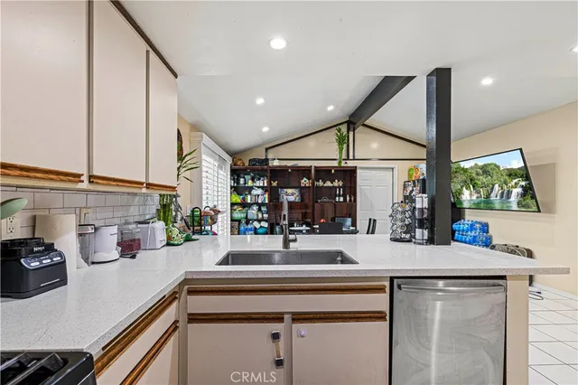 a kitchen with stainless steel appliances a sink and a large window