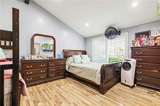 a bedroom with furniture and a wooden floor