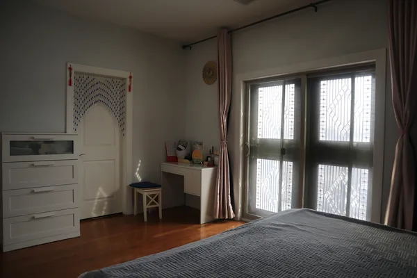 a bedroom with a bed and a window