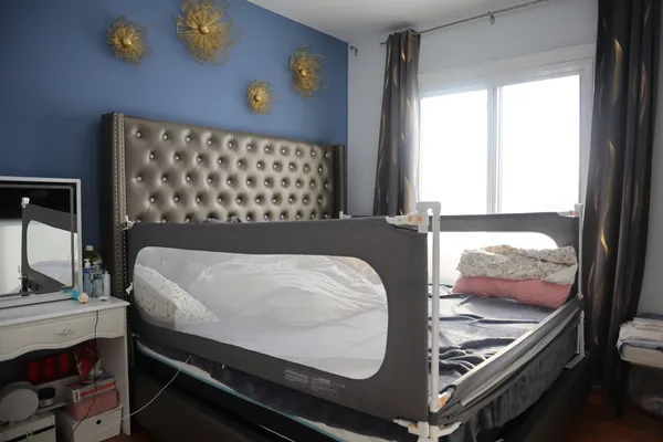 a bed sitting in a bedroom next to a window