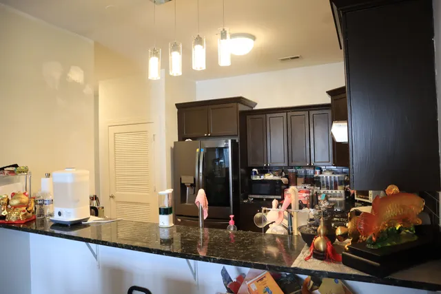 a kitchen with sink refrigerator and cabinets