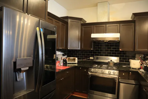 a kitchen with a refrigerator and a sink
