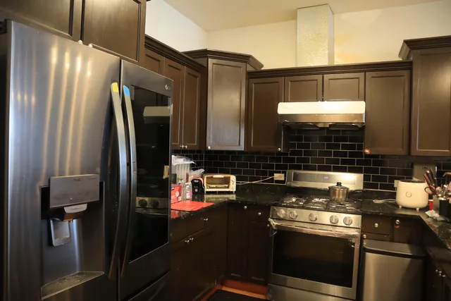 a kitchen with a refrigerator and a sink