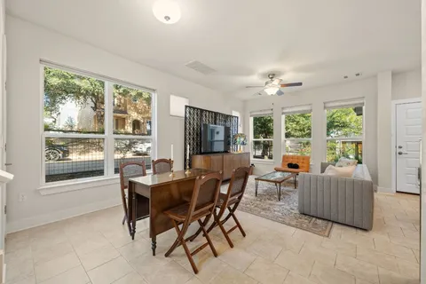 a dining room with furniture and window
