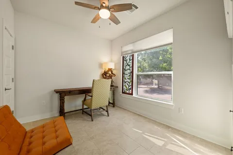 a workspace with wooden floor and a window