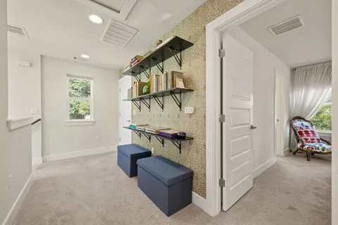 a view of hallway with stairs and furniture