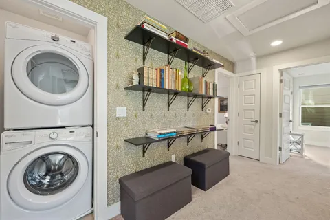 a bedroom with a bed a couch and a chandelier