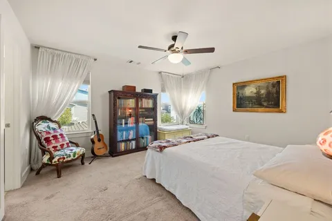 a bedroom with a bed and a chandelier