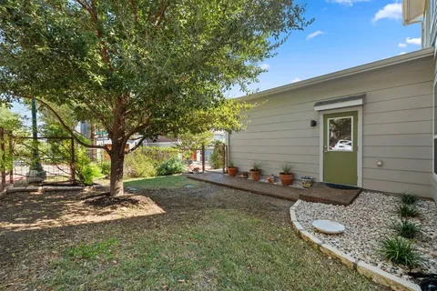 a view of a backyard with large trees