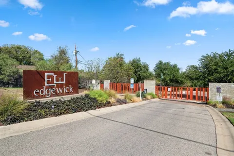 a view of a swimming pool with lawn chairs under an umbrella