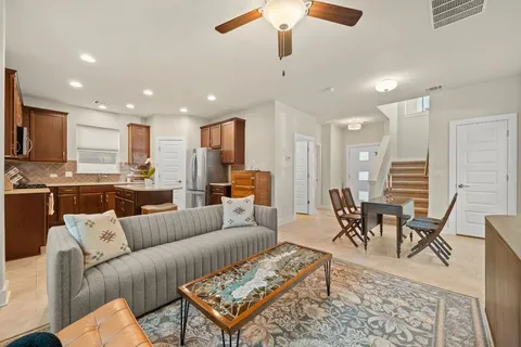 a living room kitchen with a couch and a view of kitchen