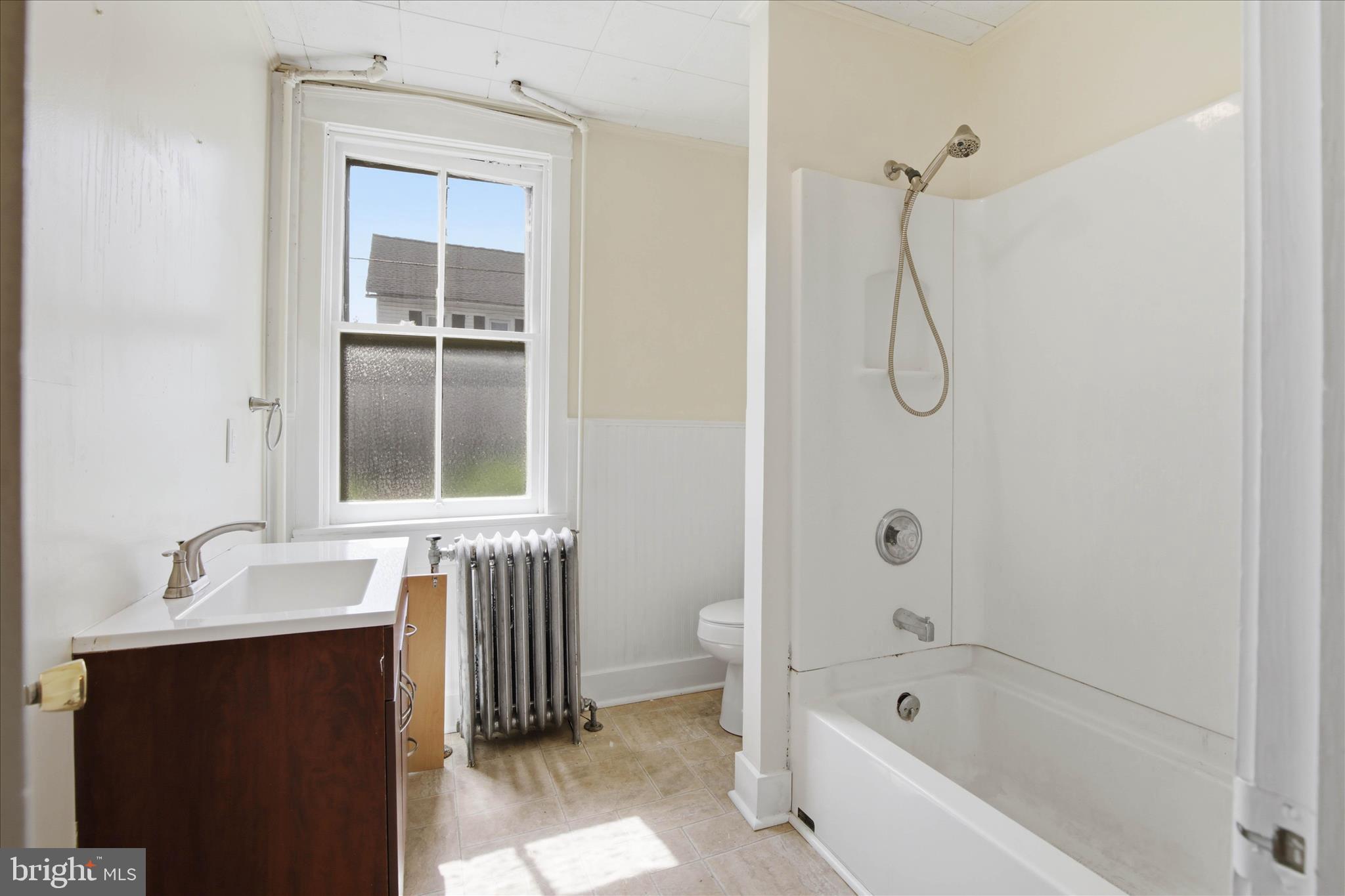 101 East Lincoln Avenue Lititz, PA 17543 - Photo 17 of 39 a bathroom with a granite countertop sink a mirror and a bathtub