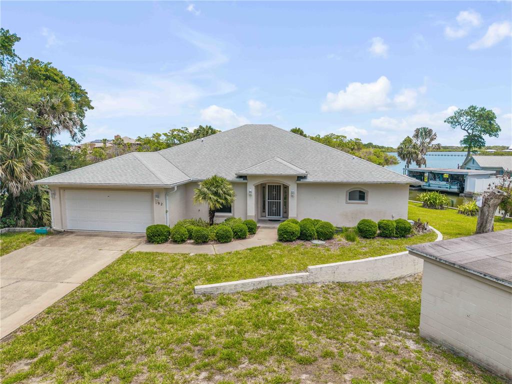 192 Azalea Road Edgewater, FL 32141 - Photo 58 of 94 a front view of a house with a yard and garage